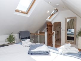 A bedroom with a bed and towels at The Workshop in Mary Tavy