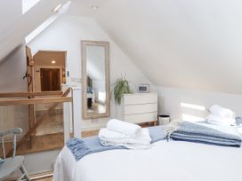 A bedroom with a bed and a mirror at The Workshop in Mary Tavy