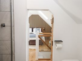 A bathroom with a shower and view of a bedroom at The Workshop in Mary Tavy