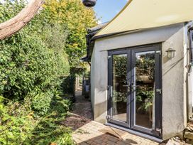 An outdoor area with a pathway leading to a door at The Workshop in Mary Tavy