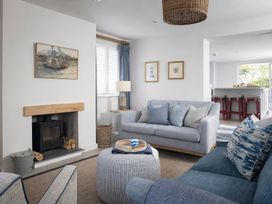 A living room with a sofa and artwork at Wood Cottage