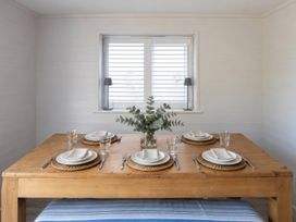 A dining room with a table set for four at Wood Cottage