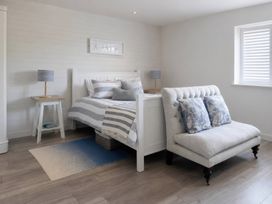 A bedroom with a bed and nightstand at Wood Cottage
