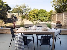 A dining area with a table and chairs at Wood Cottage
