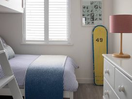 A bedroom with a bed and a lamp at Wood Cottage