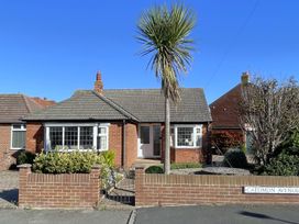 A bungalow with a palm tree on Caedmon Avenue in Whitby