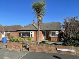 A bungalow with a palm tree and garden on Caedmon Avenue in Whitby