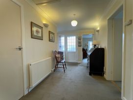 A hallway with door and chair at Roseberry in Whitby