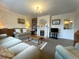 A living room with a fireplace and bookshelf at Roseberry in Whitby
