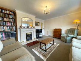 A living room with a bookshelf and fireplace at Roseberry in Whitby