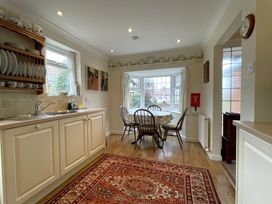 A kitchen with a dining area and window at Roseberry in Whitby