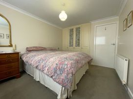 A bedroom with a bed and wardrobe at Roseberry in Whitby