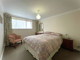 A bedroom with a bed and a chair at Roseberry in Whitby