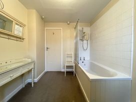 A bathroom with a bathtub and shower at Roseberry in Whitby