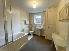 A bathroom with a bathtub, toilet, and sink at Roseberry in Whitby