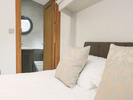A bedroom with a view of a bathroom door at Easedale Lodge near Waterside Wood 2, White Cross Bay near Windermere