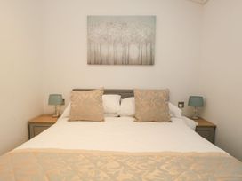 A bedroom with a bed and lamps at Easedale Lodge, Waterside Wood 2, White Cross Bay near Windermere