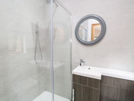 A bathroom with a shower and sink at Easedale Lodge Waterside Wood 2, White Cross Bay near Windermere