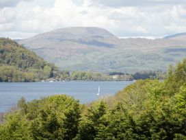 A view of a lake with trees and mountains at Easedale Lodge in Waterside Wood 2, White Cross Bay near Windermere
