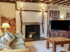 A living room with a sofa and fireplace at The Old Manor House in Lifton