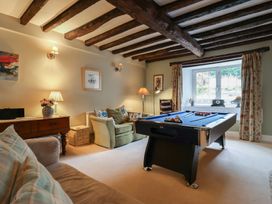 A snug with a pool table and seating at The Old Manor House in Lifton