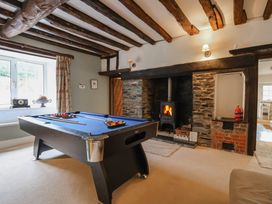 A snug with a pool table and fireplace at The Old Manor House in Lifton