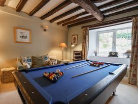 A snug with a pool table and seating area at The Old Manor House in Lifton