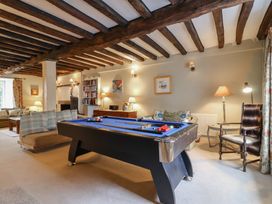 A snug with a pool table and seating area at The Old Manor House in Lifton