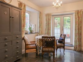 A dining room with a table and chairs at The Old Manor House in Lifton