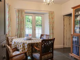 A dining room with a table and chairs at The Old Manor House in Lifton
