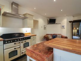 A kitchen with an oven and island at The Old Manor House in Lifton