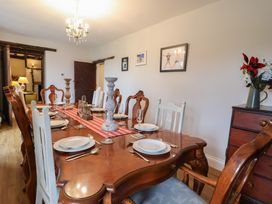 A dining room with a set table and decorations at The Old Manor House in Lifton