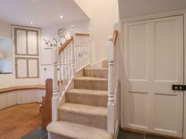 A staircase with a handrail in a hallway at The Old Manor House in Lifton