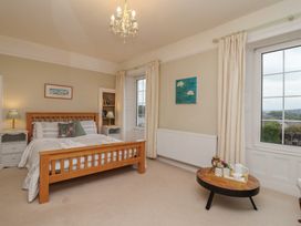 A bedroom with a bed and bedside table at The Old Manor House in Lifton