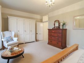 A bedroom with wardrobe and dresser at The Old Manor House in Lifton