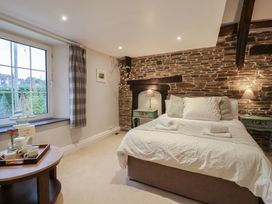 A bedroom with a bed and bedside tables at The Old Manor House in Lifton