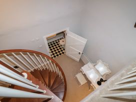A landing with a staircase and a view of a door opening to a bathroom at The Old Manor House in Lifton