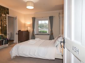 A bedroom with a bed and a window at The Old Manor House in Lifton