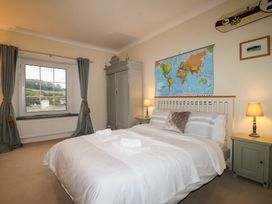A bedroom with a bed and window at The Old Manor House in Lifton