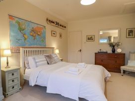 A bedroom with a bed and a world map at The Old Manor House in Lifton