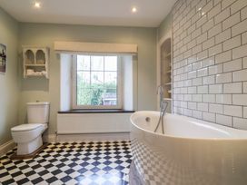 A bathroom with a bathtub and toilet at The Old Manor House in Lifton