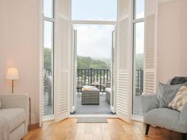 A living room with couches and doors leading to a deck at Overdale