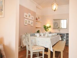 A dining room with a table set for meals at Overdale
