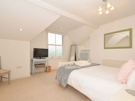 A bedroom with a bed, television, and chair at Overdale