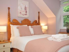 A bedroom with a bed and lamp at Overdale