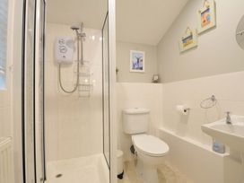 A bathroom with a shower, toilet, and sink at Overdale