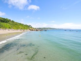A beach with clear water and cliffs in the background at Overdale
