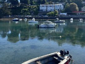 Boats in water with houses in the background at Overdale in Looe