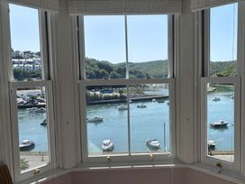 A view of boats on water from windows at Overdale in Looe