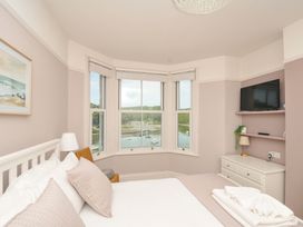 A bedroom with a view of a harbor at Overdale in Looe